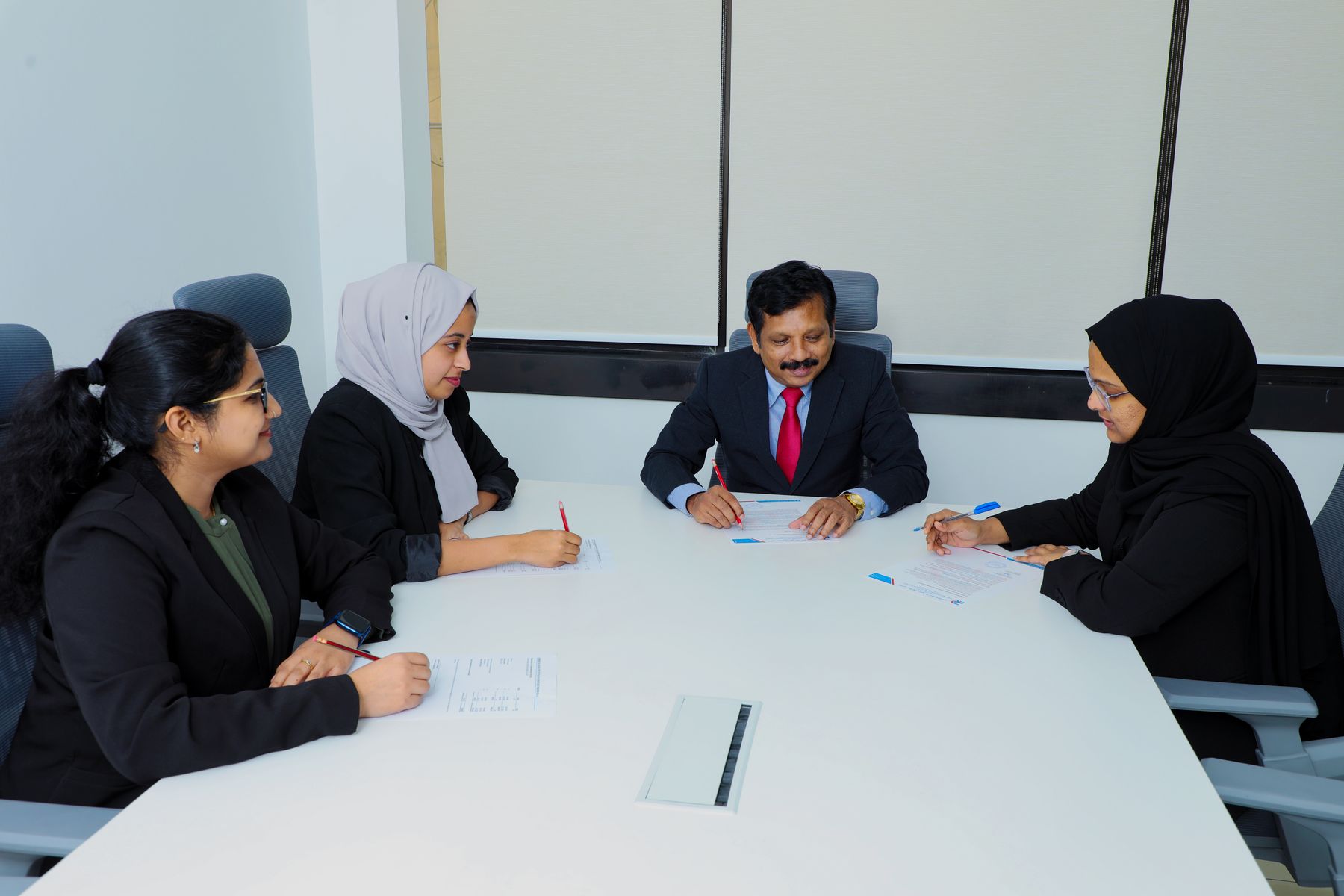 Director with staff at the board table