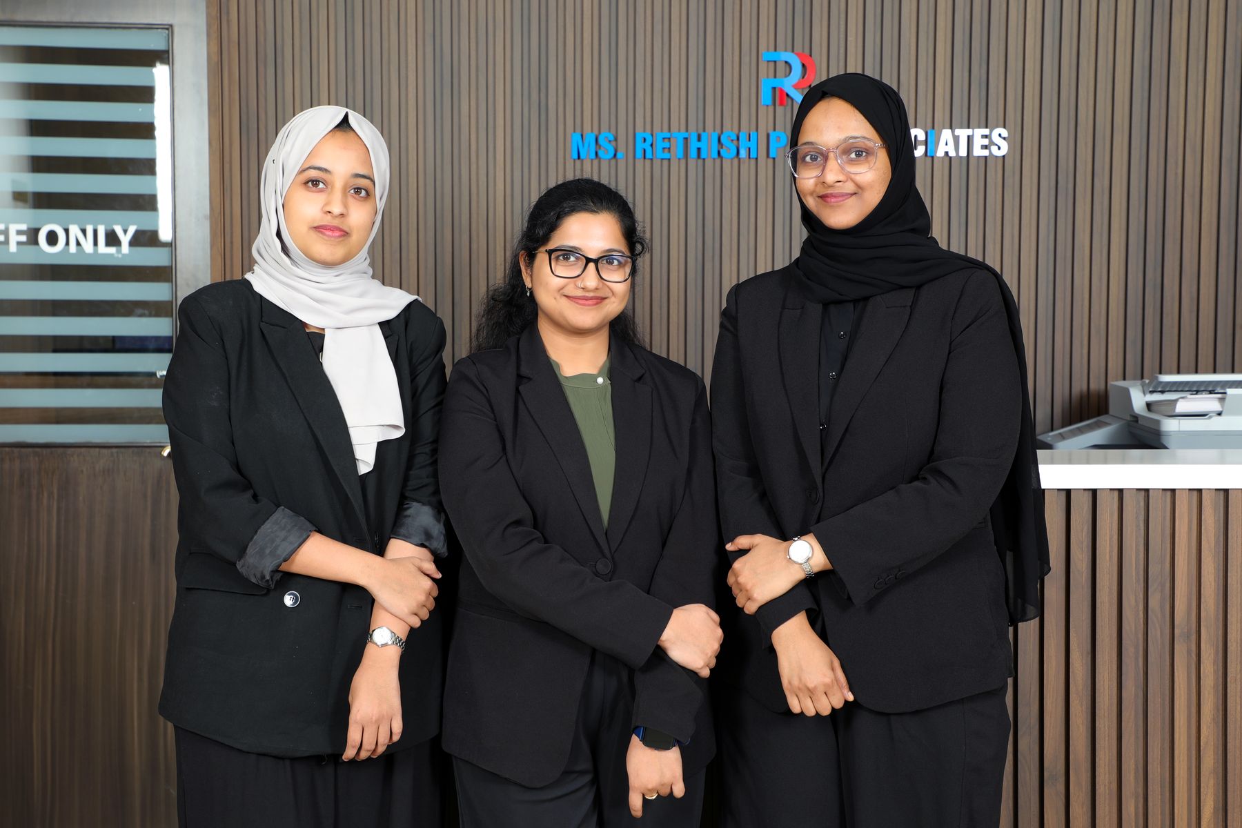 Audit managers in front of the brand wall