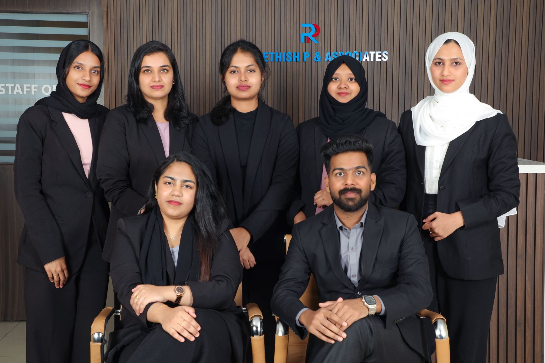 Audit staff in front of the brand wall